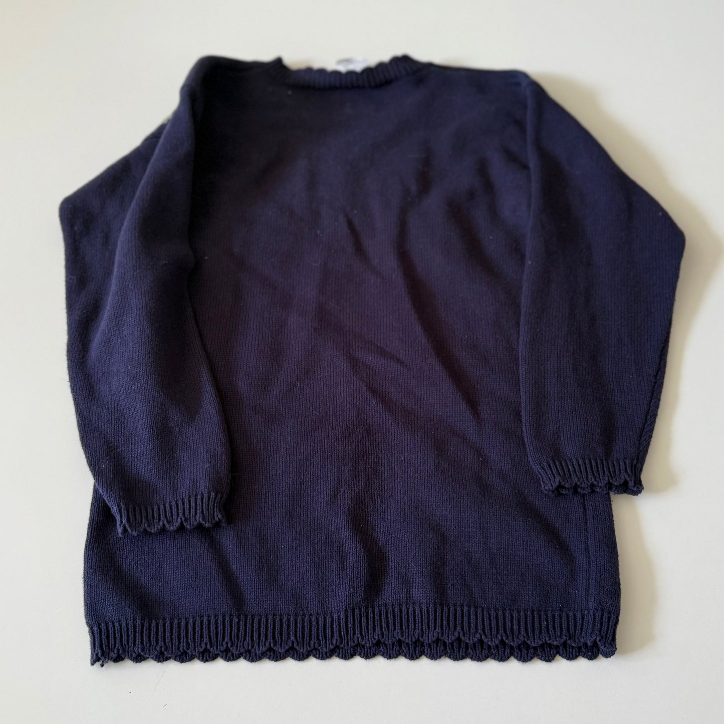 Navy blue sweater on a white background