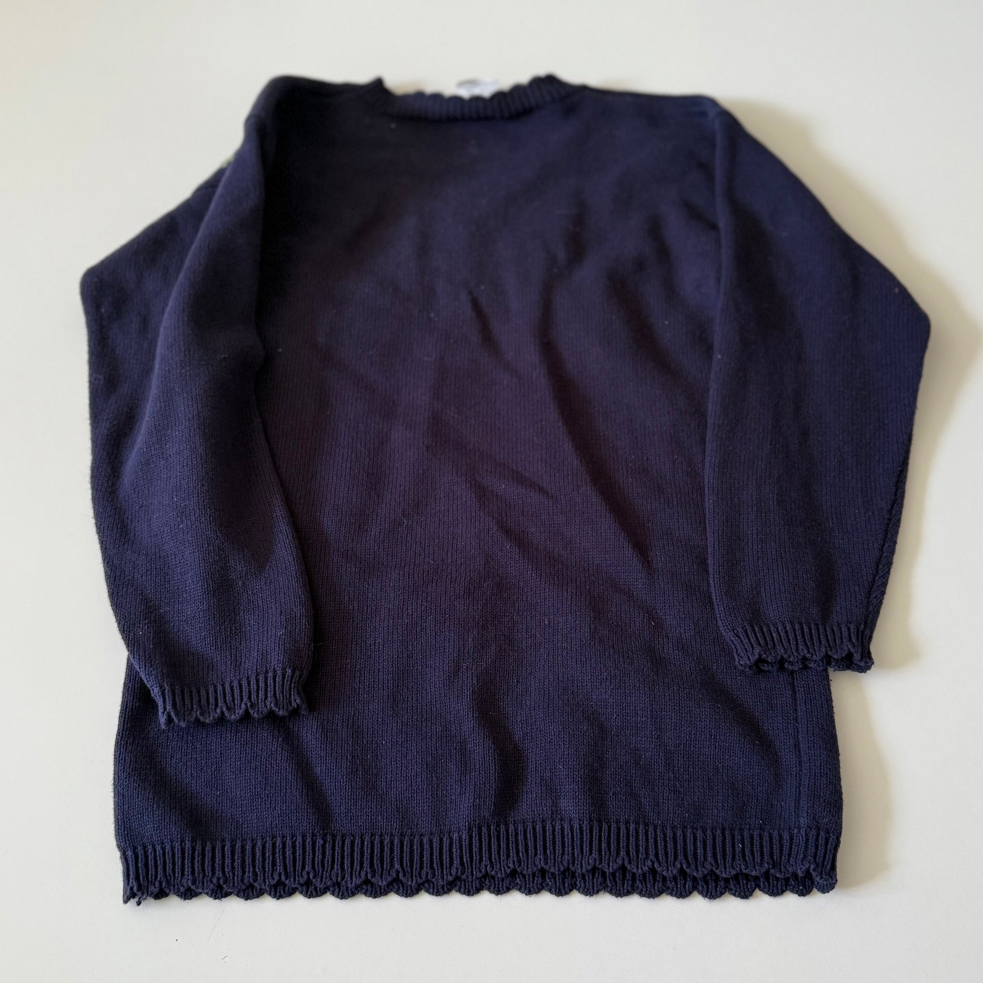 Navy blue sweater on a white background