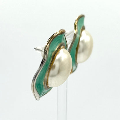 Pair of earrings with green and gold design on a white background
