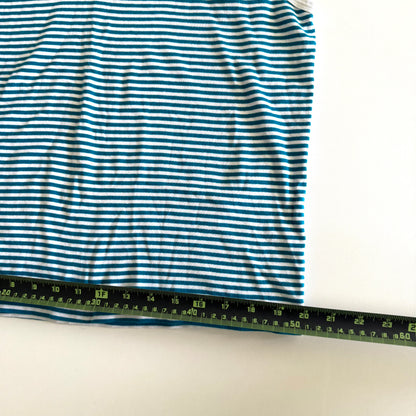 White and turquoise striped tank top with polo neckline, on a white backdrop and a measuring tape laid on top of it. 