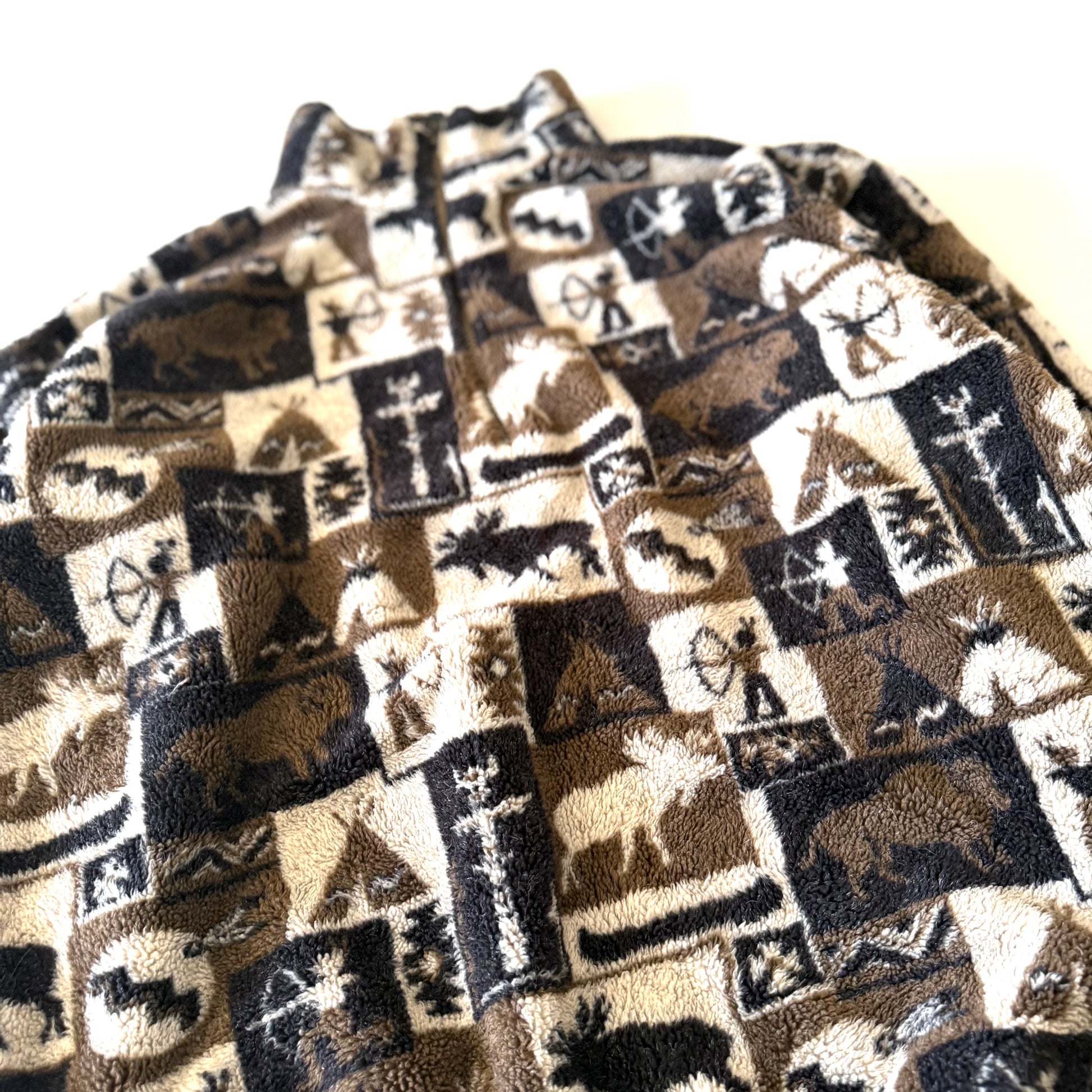 Moose and other camping motif quarter zip fleece on a white background.