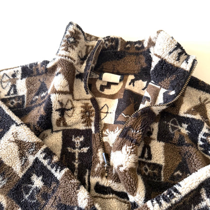 Moose and other camping motif quarter zip fleece on a white background. This photo is a close up of the zipper open. 