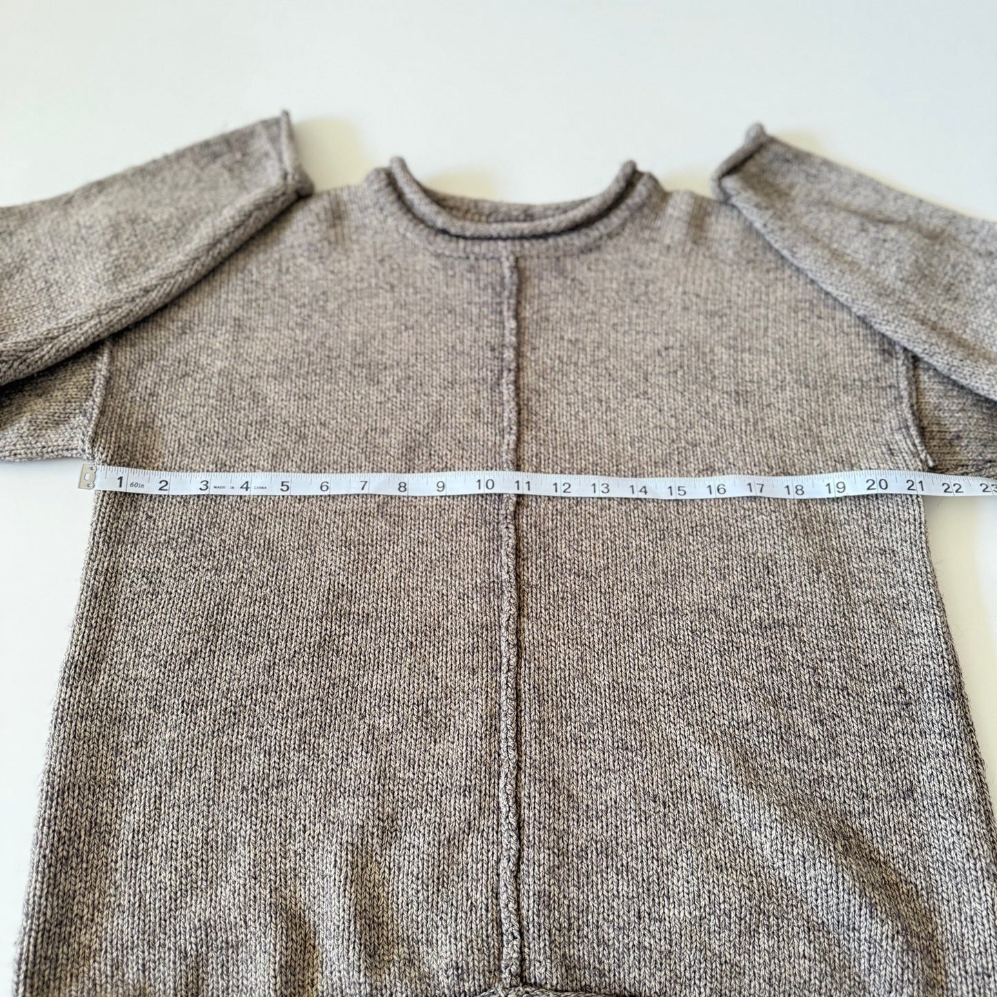 sweater with measuring tape on it