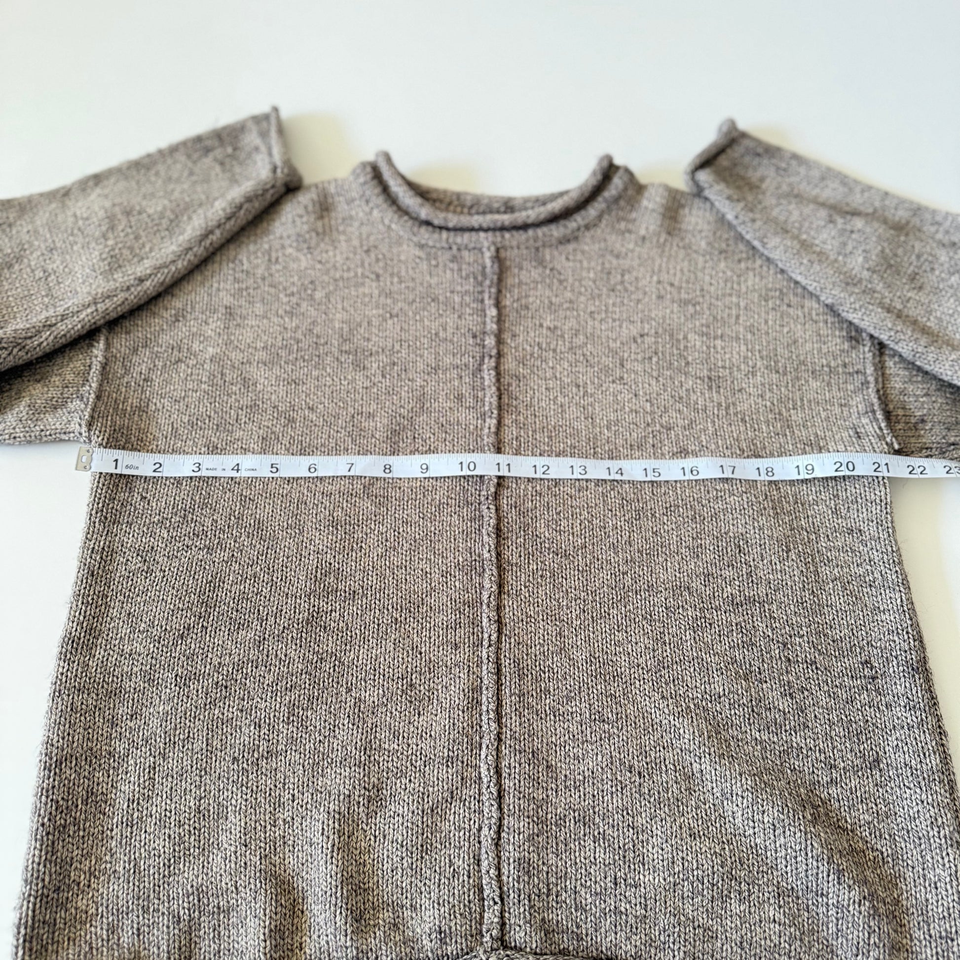 sweater with measuring tape on it