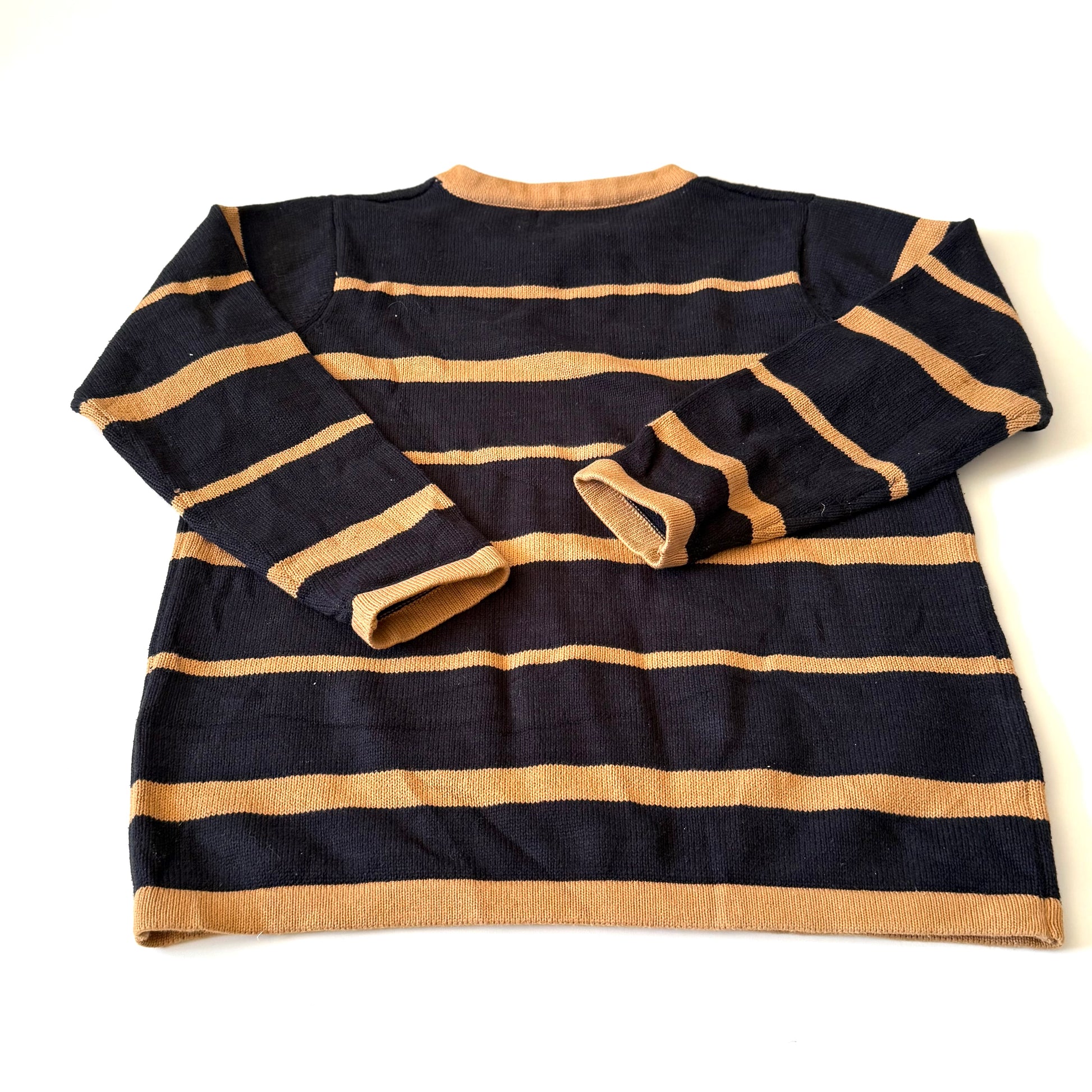 Black and beige striped sweater on a white background