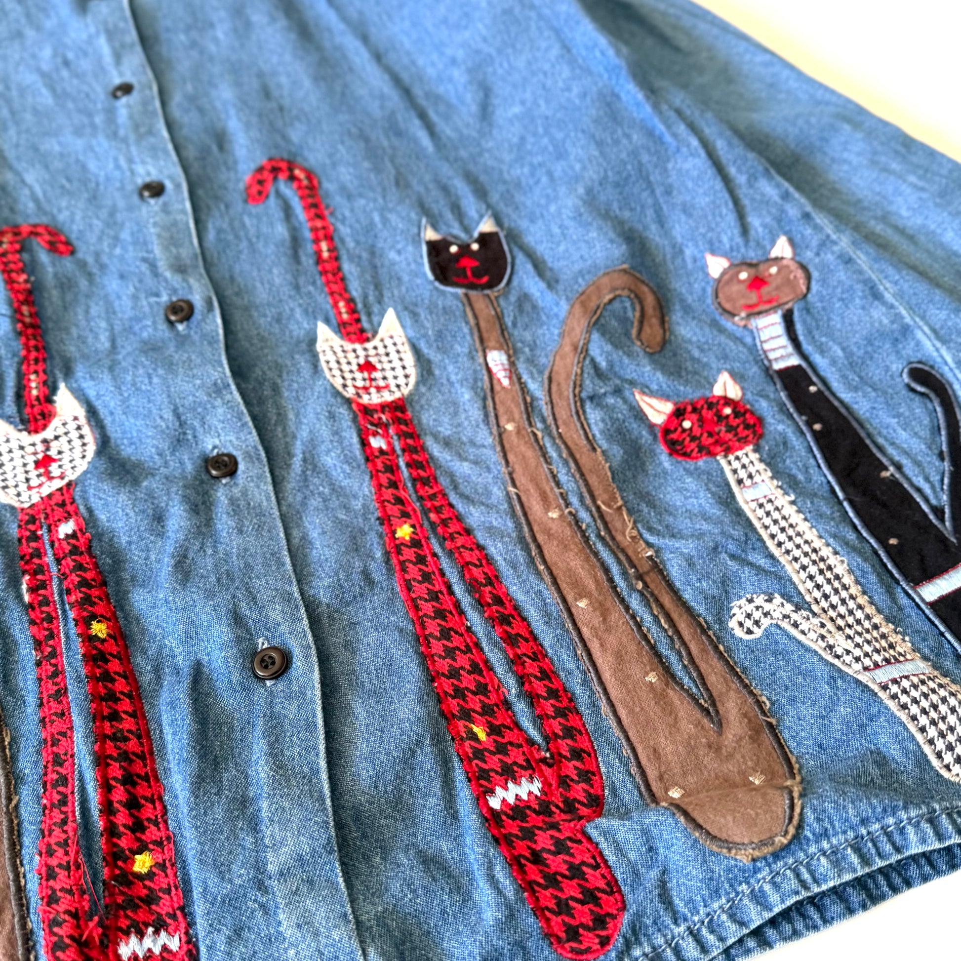 Collection of cat-shaped straps on a denim background