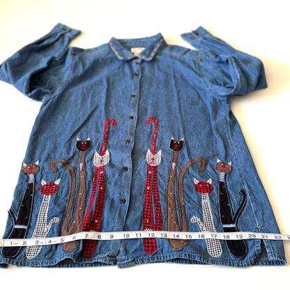 Blue denim shirt with cat appliqués on a white background